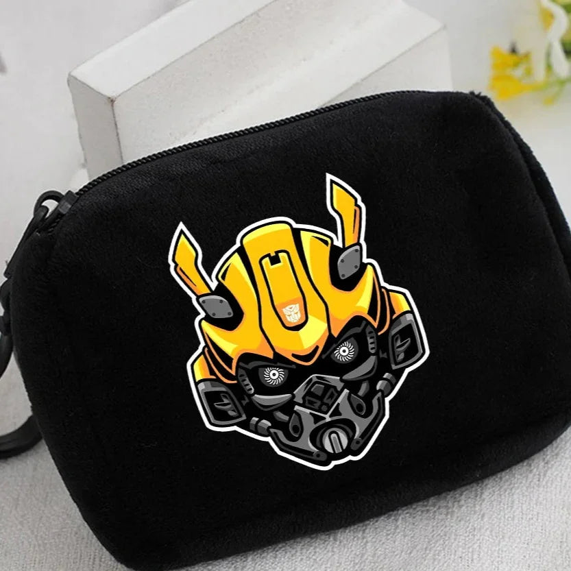 Pochette noire avec motif tête de Bumblebee jaune, style cartoon, sur fond clair – Transformers.