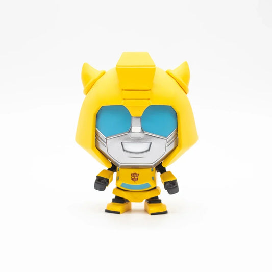 Figurine vinyl Bumblebee jaune et argent souriant, style cartoon sur fond blanc – Transformers.